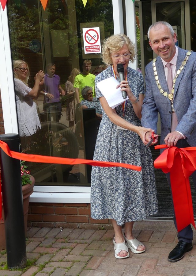 The Deputy Mayor and Zara Ross, CEO of Ben, are cutting a red ribbon at the opening of the newly refurbished Town Thorns Care Home.