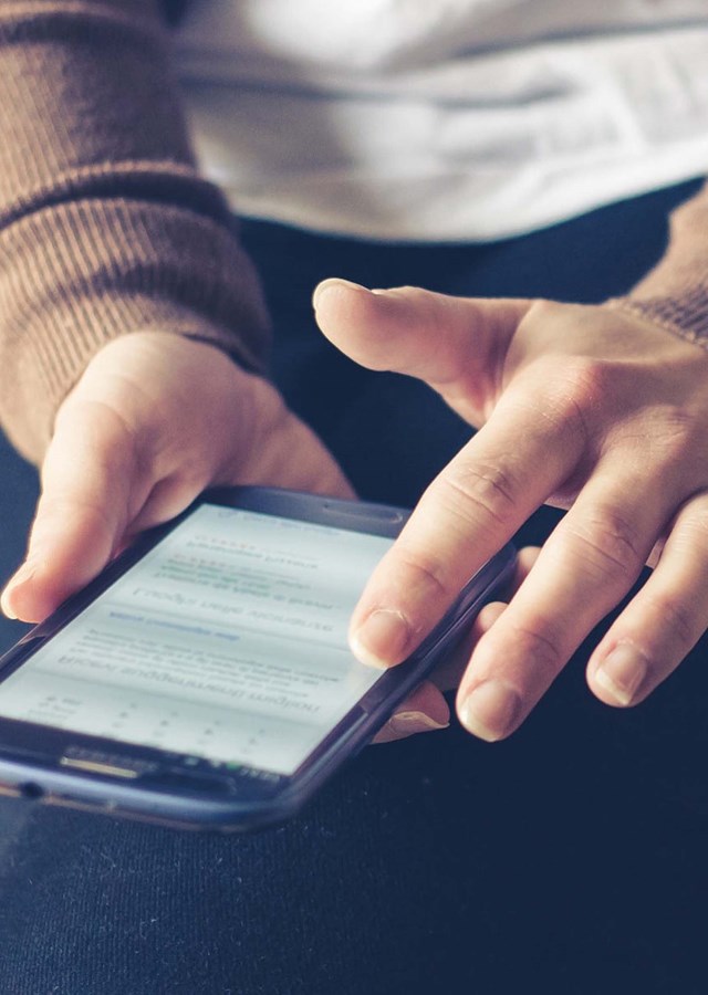 Person scrolling on a smart phone