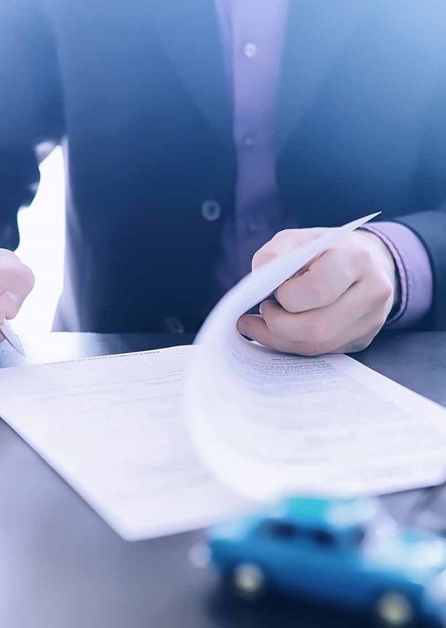 Man going through important documents on a desk